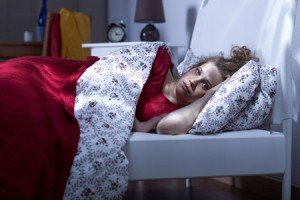 53936084 - horizontal image of a young sleepless woman lying in bed
